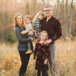 Family in coordinated outfits for a photoshoot