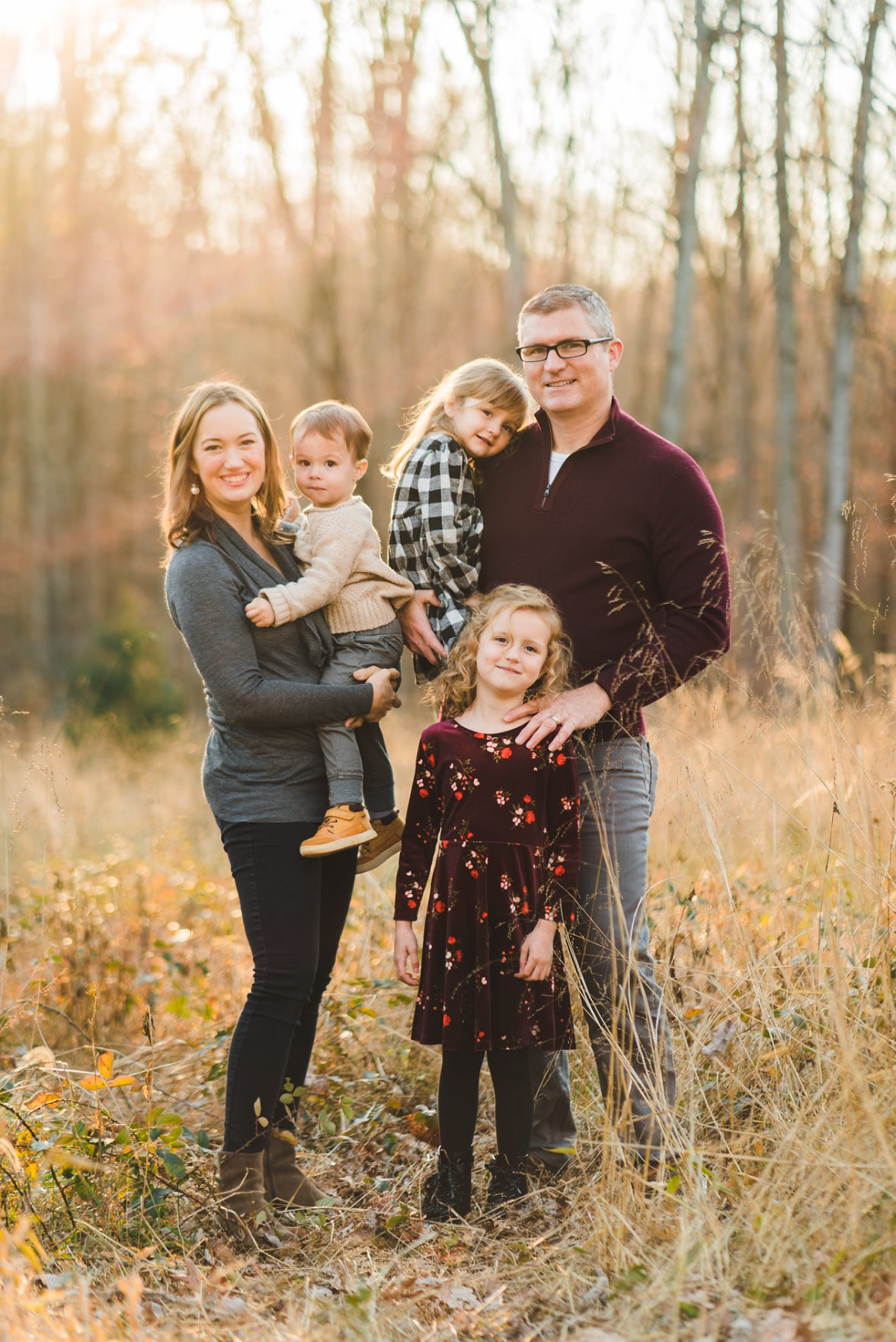 Family in coordinated outfits for a photoshoot