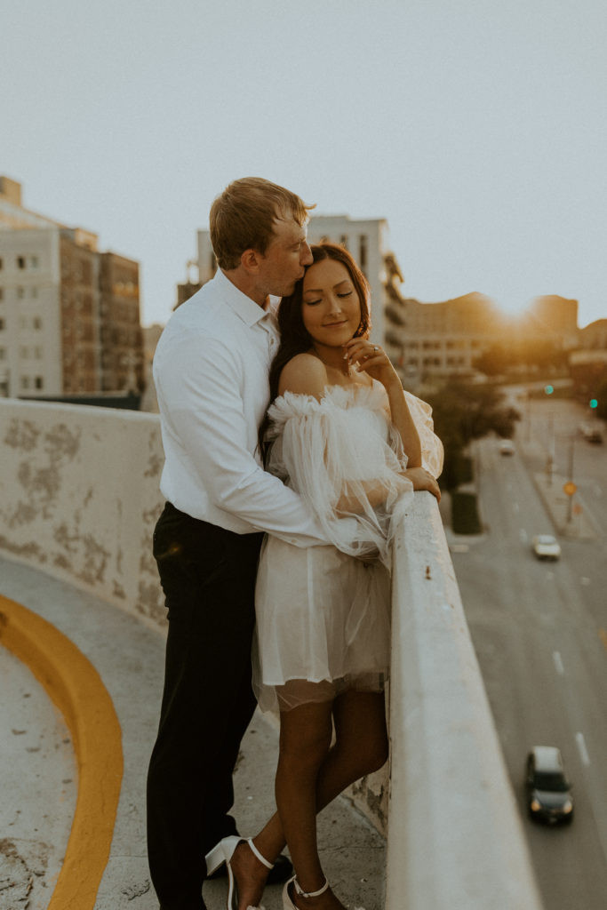 Engagement photo of a stylish couple in dressy outfits, demonstrating the elegance of a formal outfit choice for engagement photos.