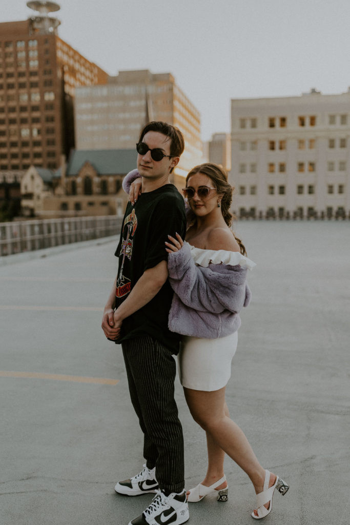 Close up engagement photo of a smiling couple with sunglasses, highlighting how accessories can enhance engagement photos.