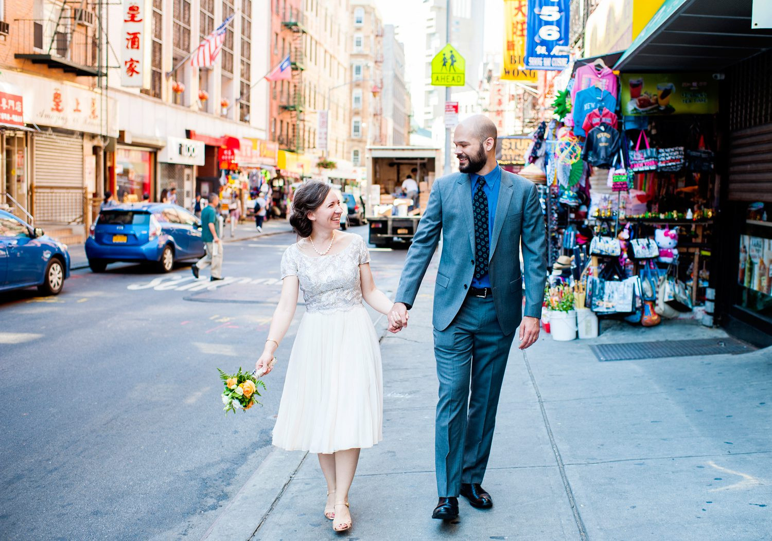 Woman in white dress poses in Chinatown