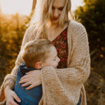 Newborn baby sleeping peacefully in parents' arms, captured in a natural lifestyle setting