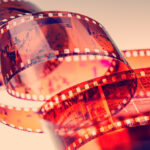 A close-up of a strip of film negatives, showcasing the inverted images and tonal range captured during the photographic process
