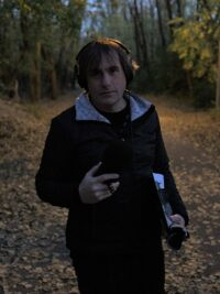 Aubrey Ralph recording in the woods. (Photo by Ginger Williamson)
