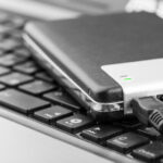 External hard drive connected to a laptop, showcasing data storage accessibility