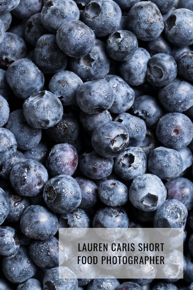 Photo of blueberries with a huge obscuring watermark. A photo of blueberries is shown with a large, semi-transparent watermark obscuring much of the image, illustrating how intrusive watermarks can negatively impact the visual appeal of a photograph
