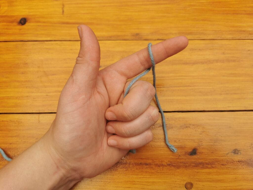 Wrapping the yarn creates the necessary loop for starting the crochet slip knot