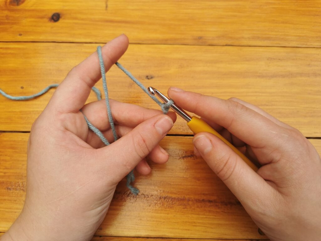 Holding the slip knot secures the base for the initial chain stitch