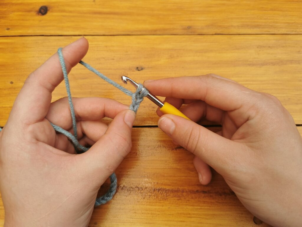 Pulling through the chain creates two loops on the hook, ready for completing the single crochet