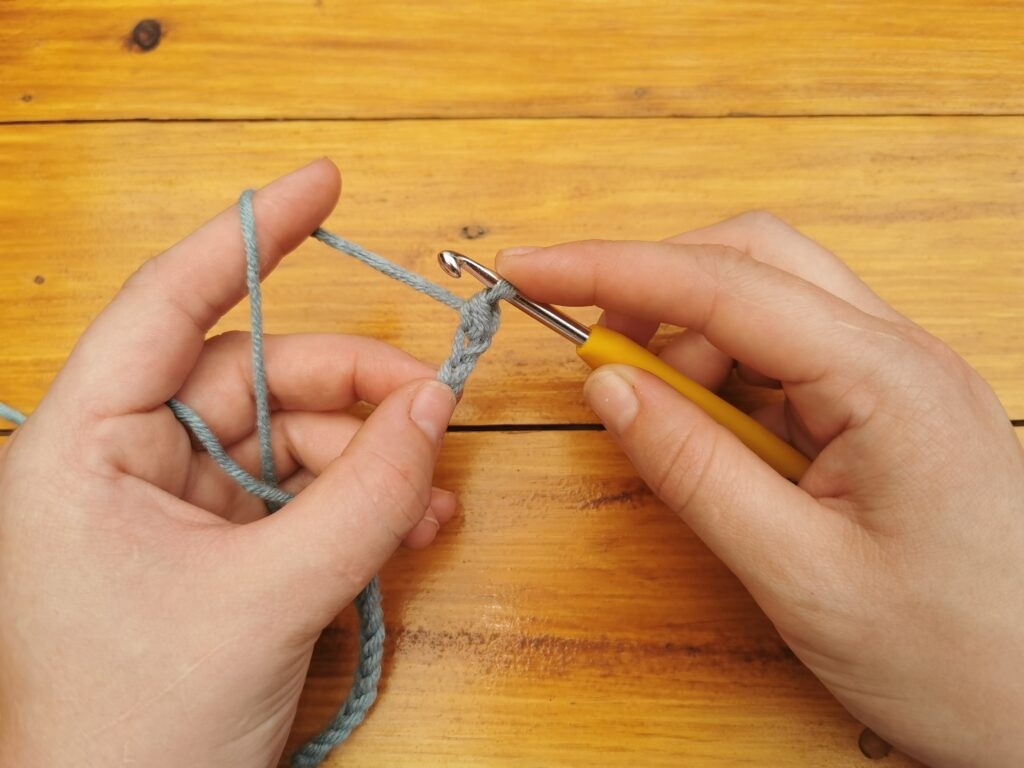 Pulling through both loops finalizes the single crochet, leaving one loop on the hook