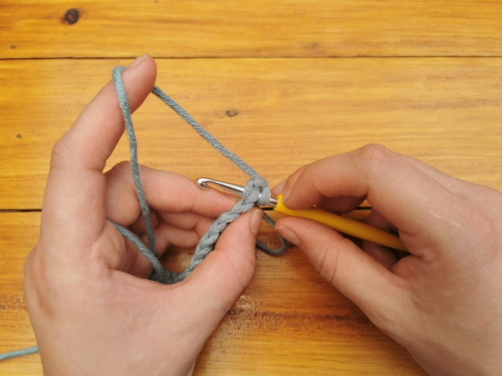 The V-shape indicates the correct stitch for inserting the hook, ensuring proper stitch formation