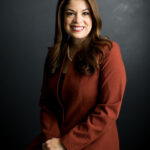 Woman wearing black blazer for professional headshot, showcasing dfphoto.net's advice on classic attire