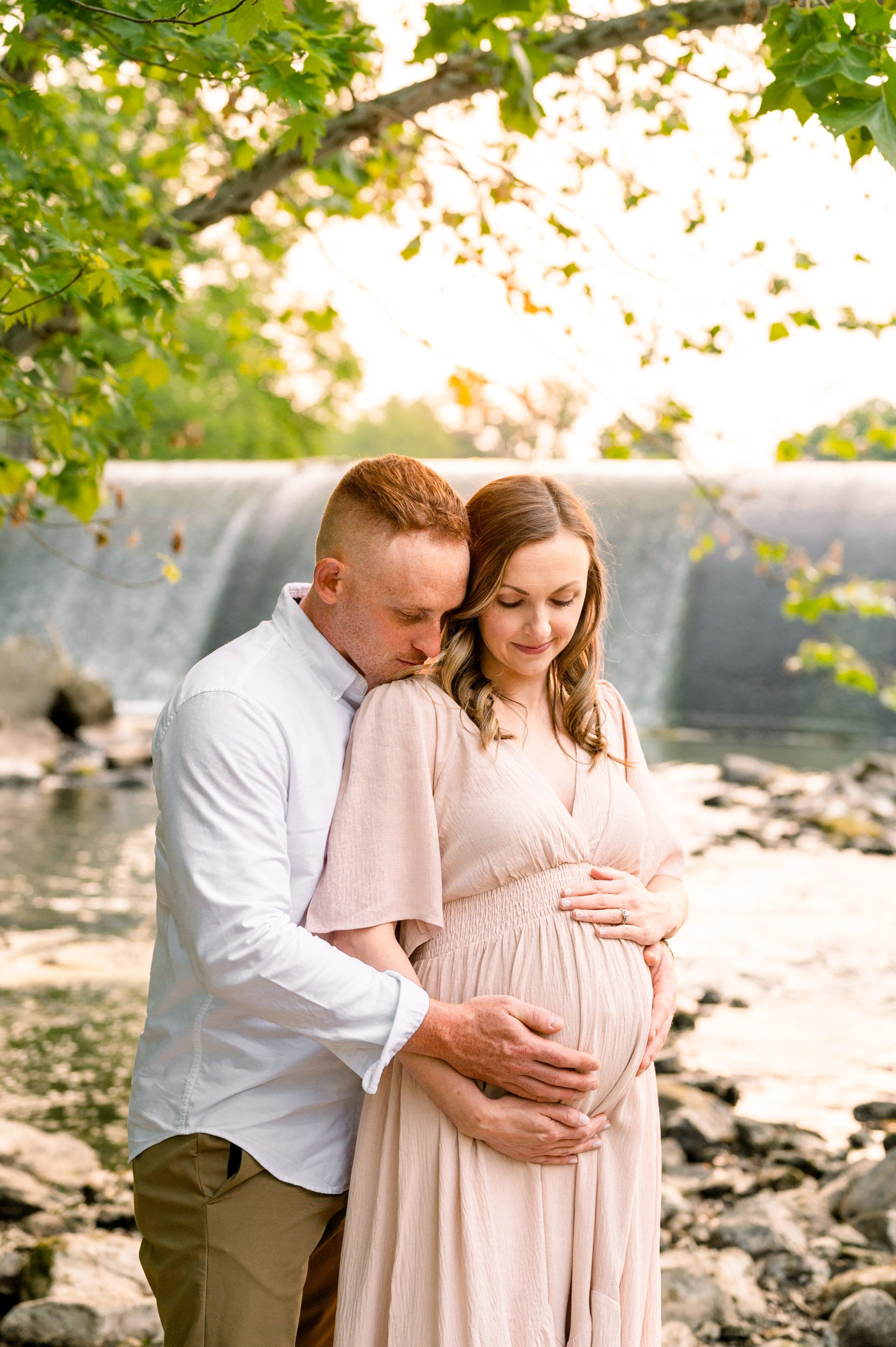 Expecting parents at waterfall, captured at 32 weeks