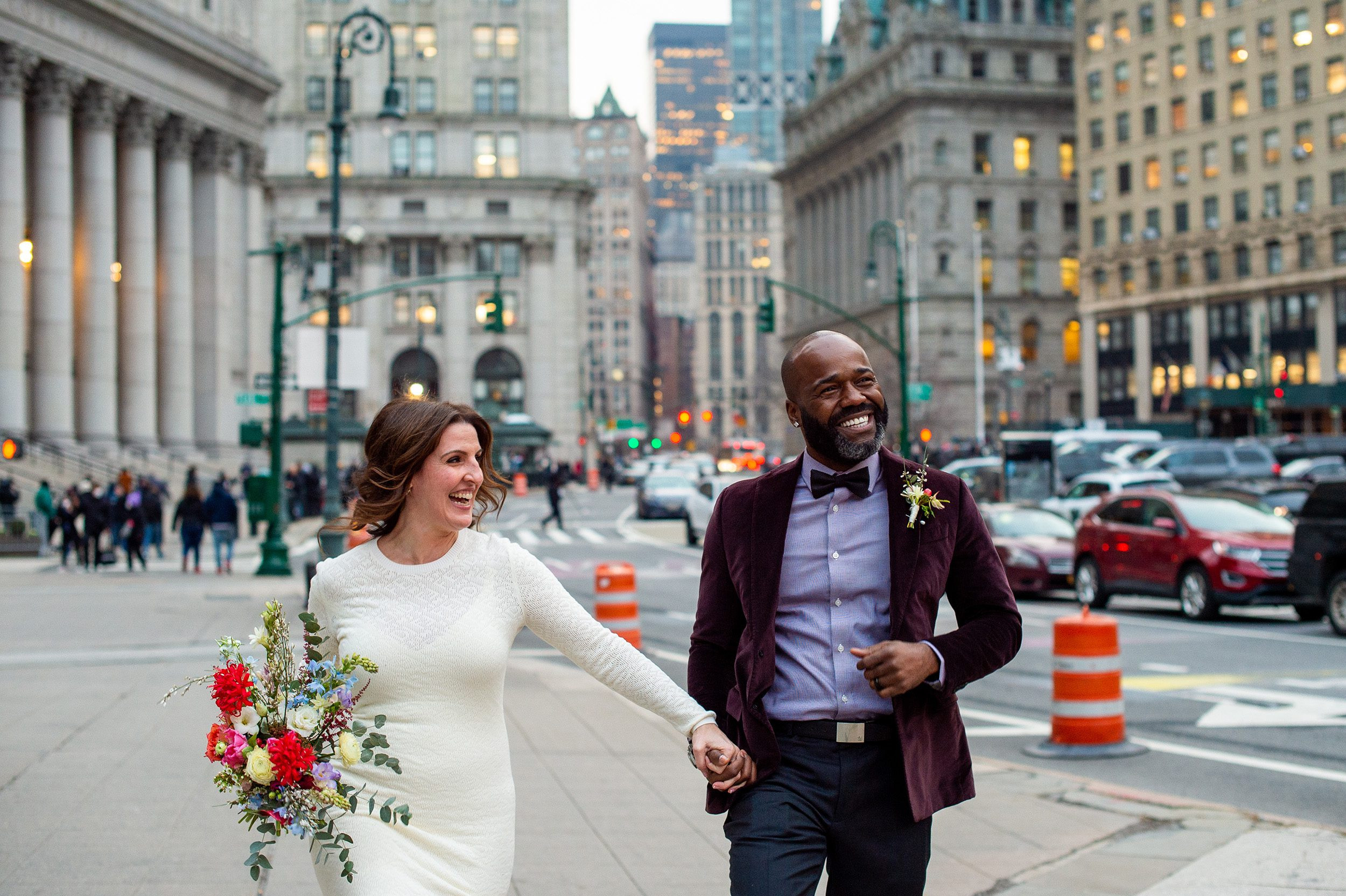 Couple posing on steps of building near City Hall