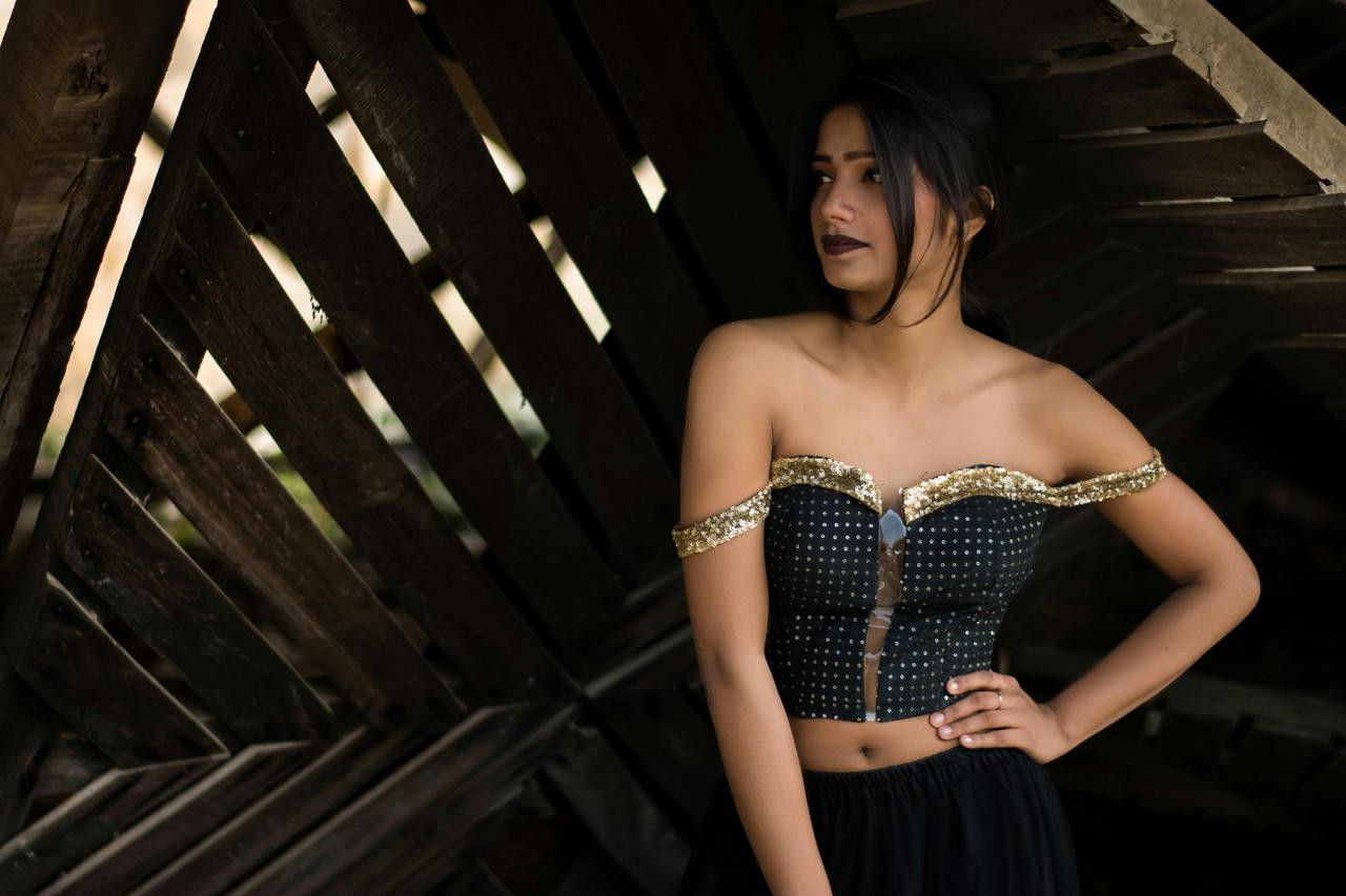 A woman in front of Wooden Backdrop