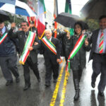 Thomas Principe Esq., a former parade Grand Marshal (center) with Grand Marshal Clemente Lopes (center left) (Photo by Walter Karling)