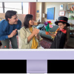 An iMac displaying people using Center Stage, highlighting its functionality for video calls and photography, enhancing user engagement and visual experience.