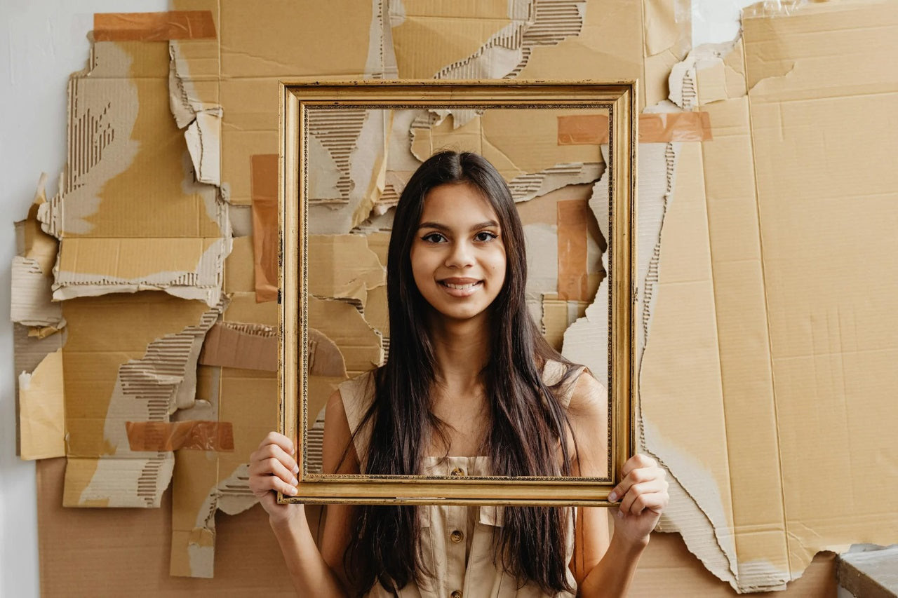 A girl pose in front of the Cardboard Backdrop.
