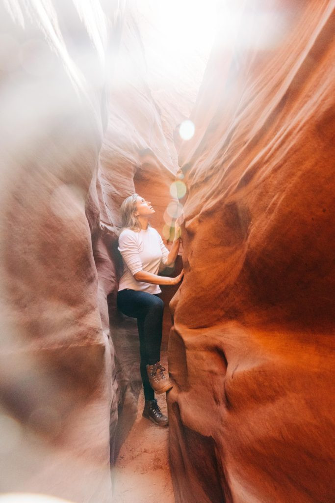 Person overlooking a vast canyon at sunset, showcasing a unique perspective