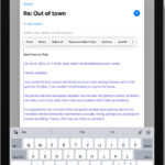 Draft email in progress with attachment options displayed above the keyboard