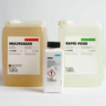 jugs of dark room chemicals; developer, fixer, stop bath