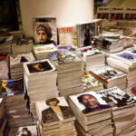 Young photographer looks magazines submission