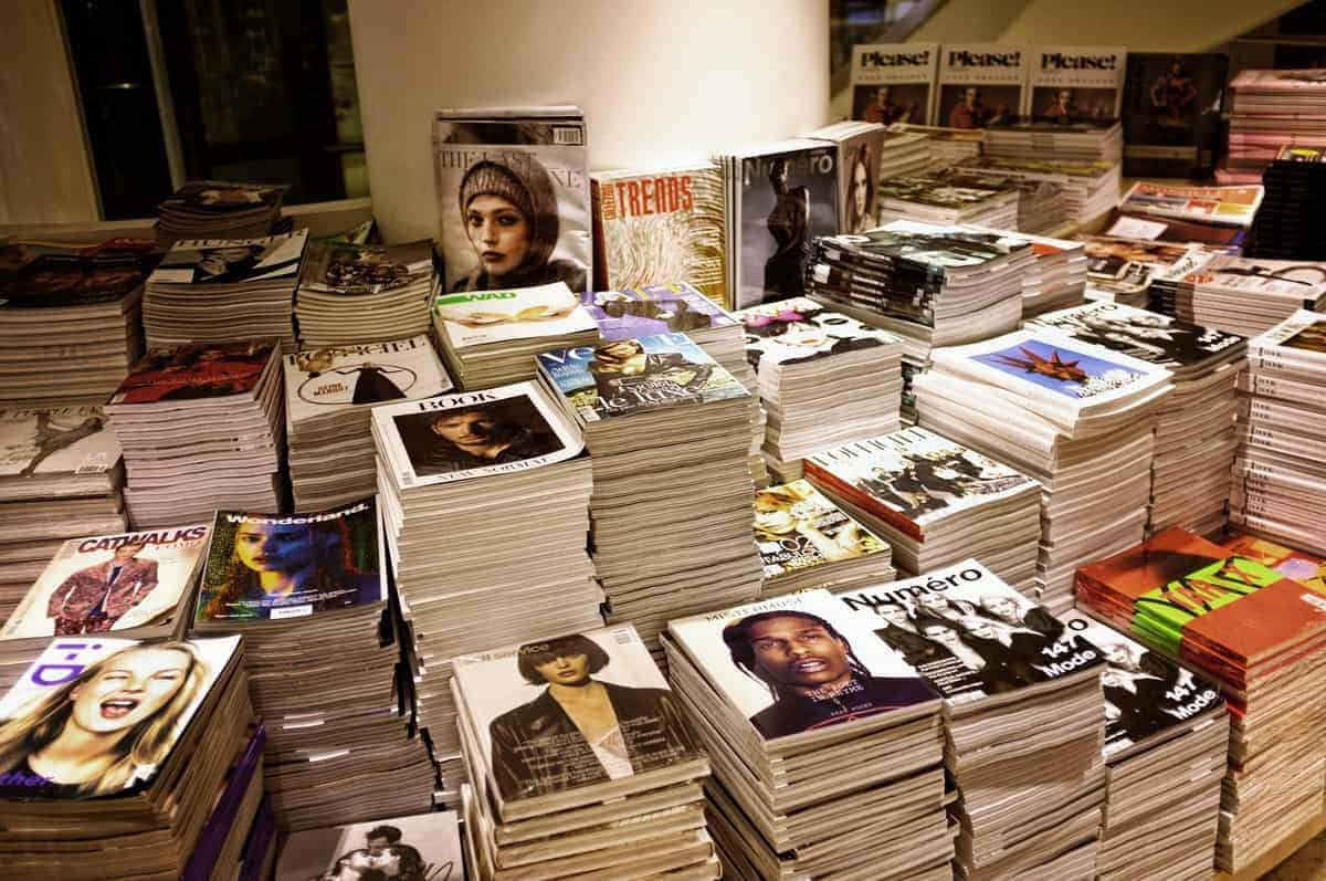 Young photographer looks magazines submission