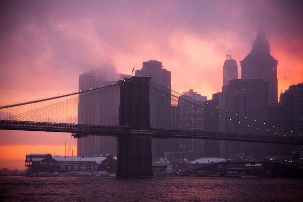 Image of the Brooklyn Bridge at sunset during a snowstorm with a white vignette