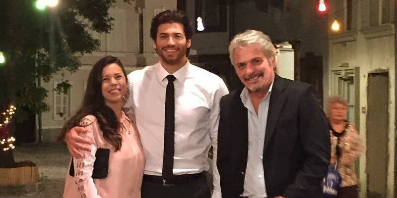 A family photo of Can Yaman, capturing a casual moment that showcases his close bond with his family members and his authentic self.