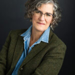 Woman wearing a solid color dress for professional headshot