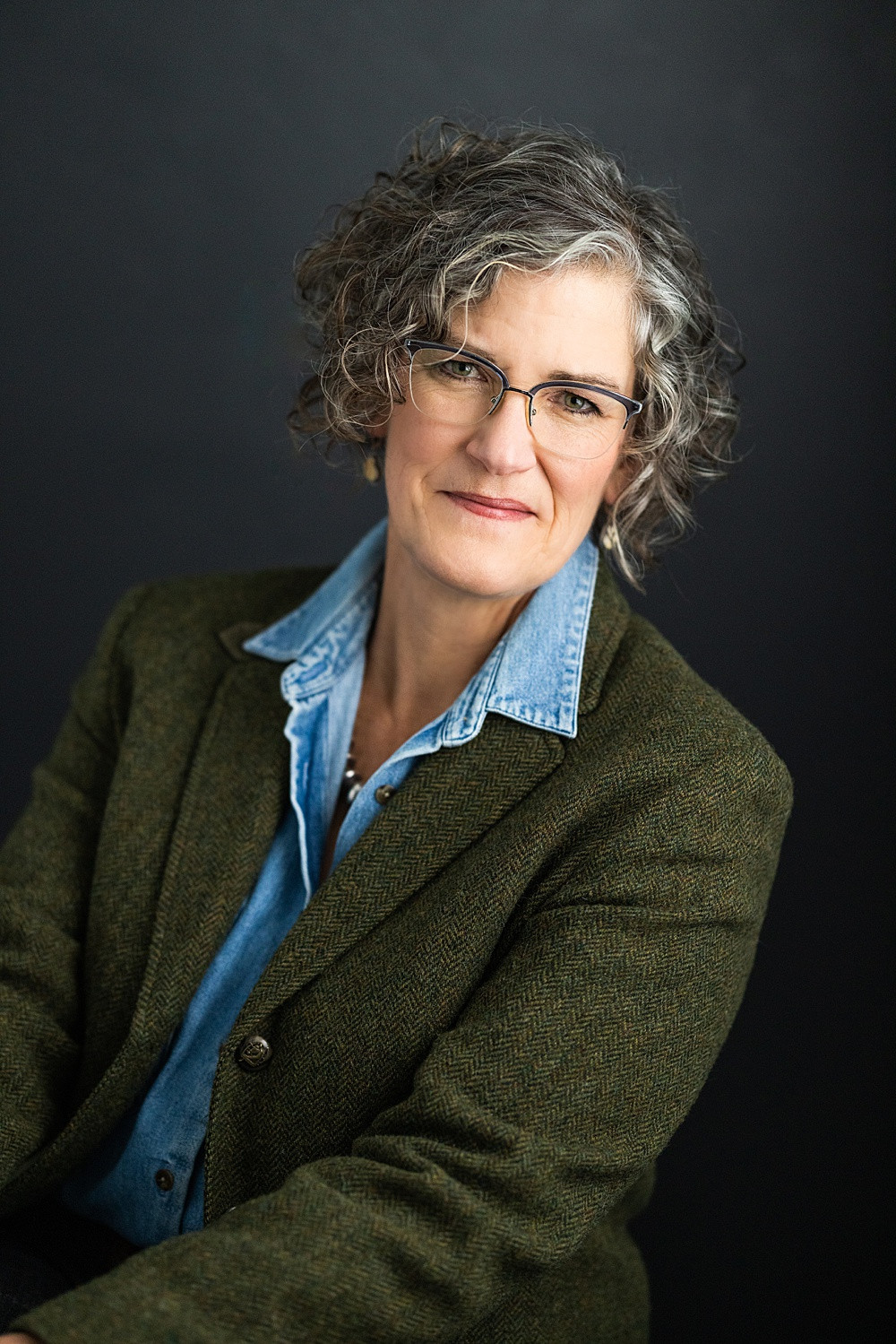 Woman wearing a solid color dress for professional headshot