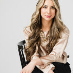 Professional headshot attire featuring a navy blazer, a crisp white shirt, and subtle jewelry