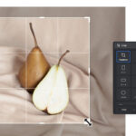 A display of various sized photo prints, including a 5x7, in a photography studio.