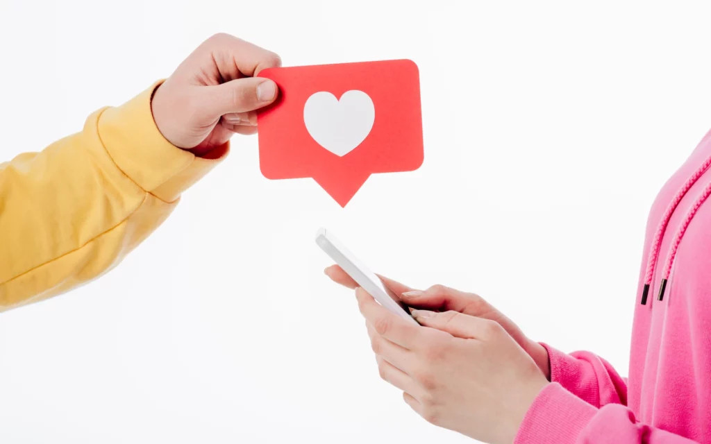 Man holding a heart symbol, representing the importance of audience engagement and connection