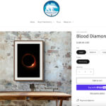 Product page for a print of a moon with a red border against a black background.