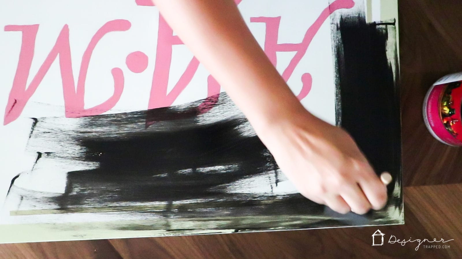 Painting the sides of a canvas with black acrylic paint