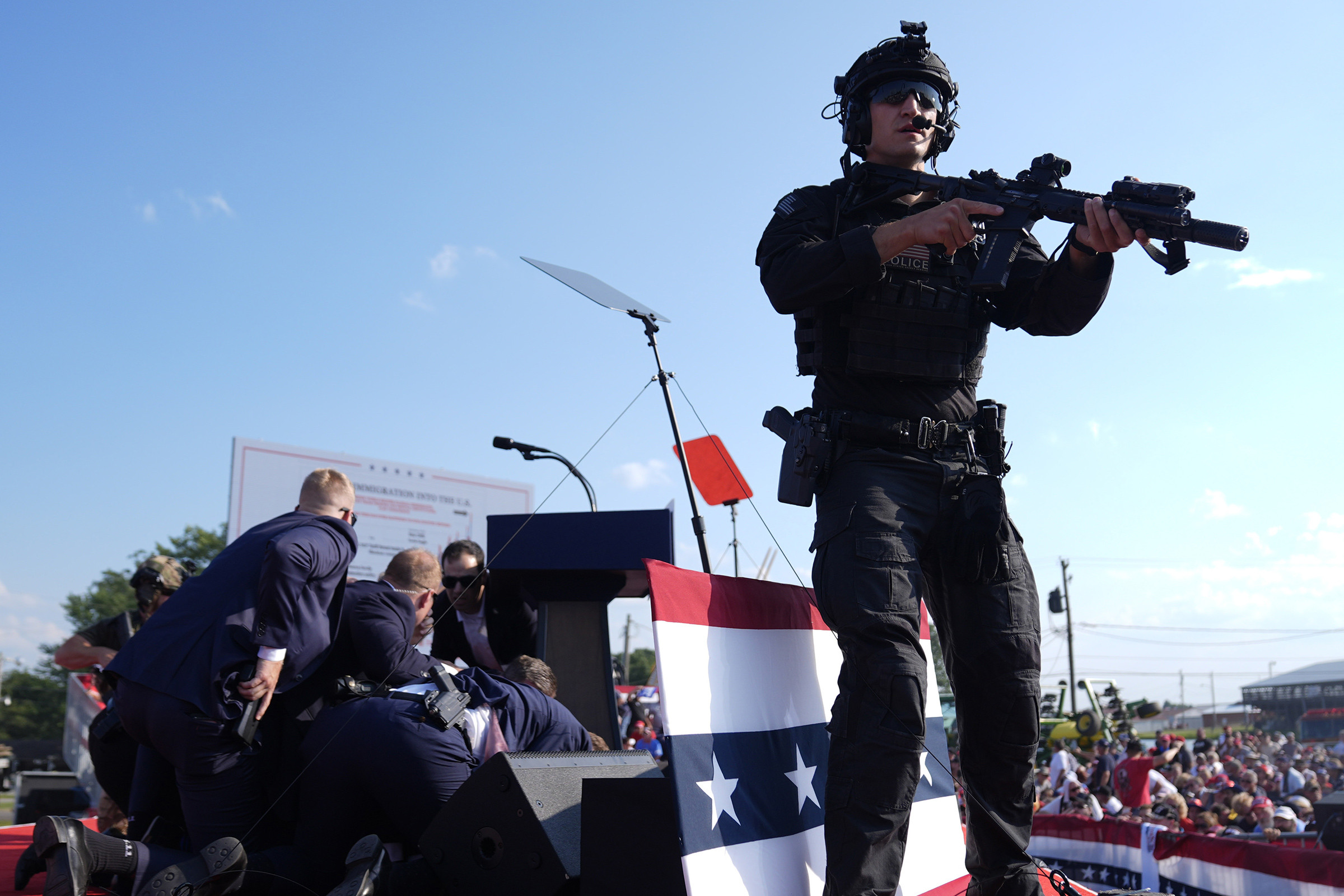 Republican presidential candidate former President Donald Trump is covered by U.S. Secret Service agents at a campaign rally.