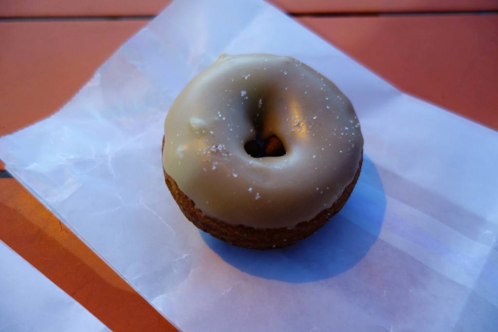 A pair of maple glaze cake donuts from A Baker's Wife's Pastry Shop, showcasing the glaze and texture