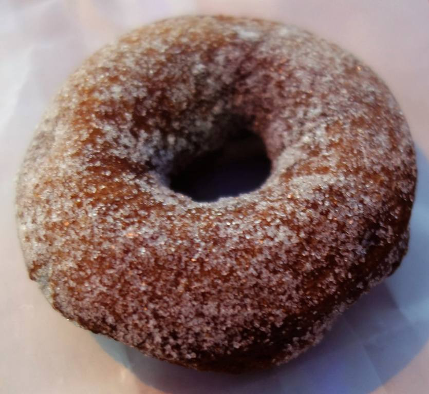 A close-up shot of a sugar cherry cake donut from A Baker's Wife's Pastry Shop, highlighting the texture and glaze