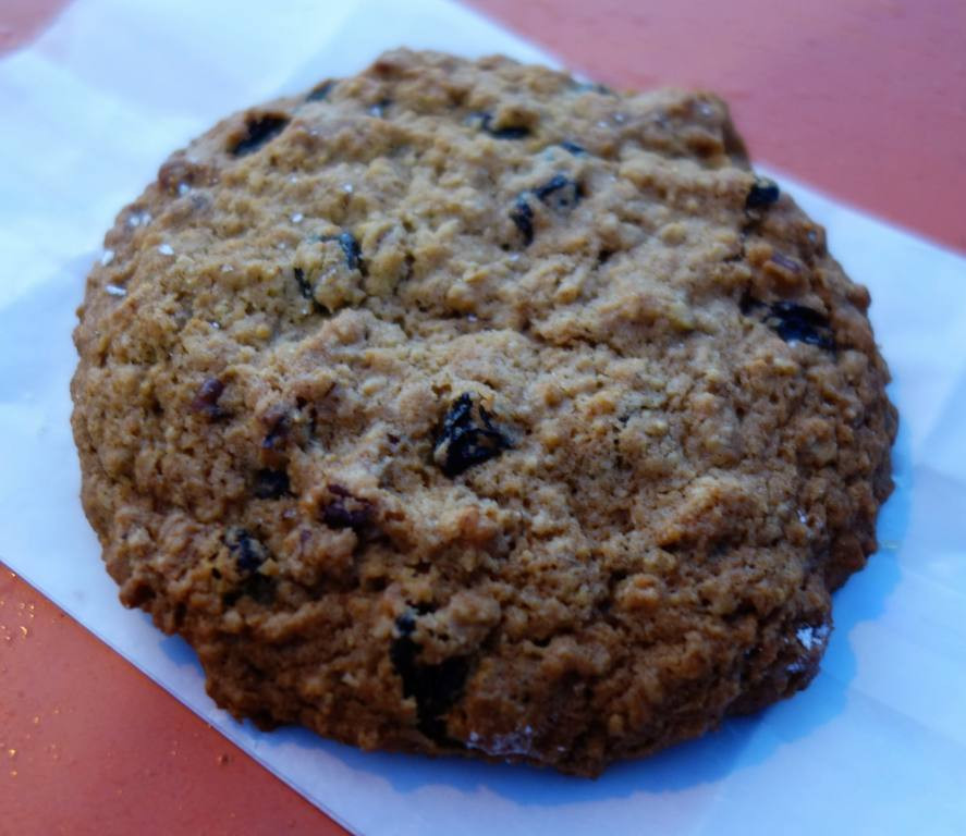An oatmeal raisin cookie from A Baker's Wife's Pastry Shop, displaying its chewy and textured appearance