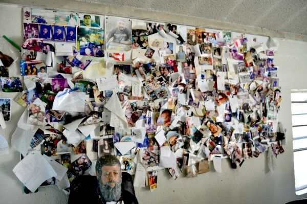 Interior view of the shrine, showcasing the array of candles, photos, and heartfelt messages left by visitors