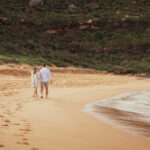 Couple laughing during engagement photo session, showcasing natural and joyful moments