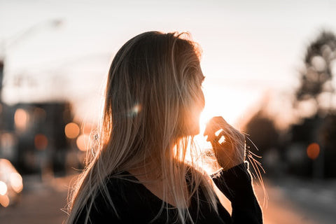 Girl watching the horizon during sunset, demonstrating the potential for glare