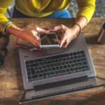 Connecting an Android phone to a laptop with a USB cable, displaying the file transfer interface.