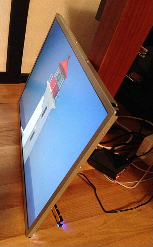 Monitor with the plastic casing removed, showing the bare electronics and screen