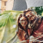 Photo blanket with a family photo, protected in a mesh laundry bag before washing, ensuring gentle care and preventing damage.