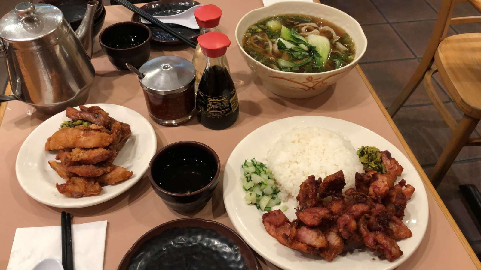 Fried chicken and rice, and a pork chop with noodle soup dish from A&amp;J Restaurant showcasing delicious and authentic cuisine.