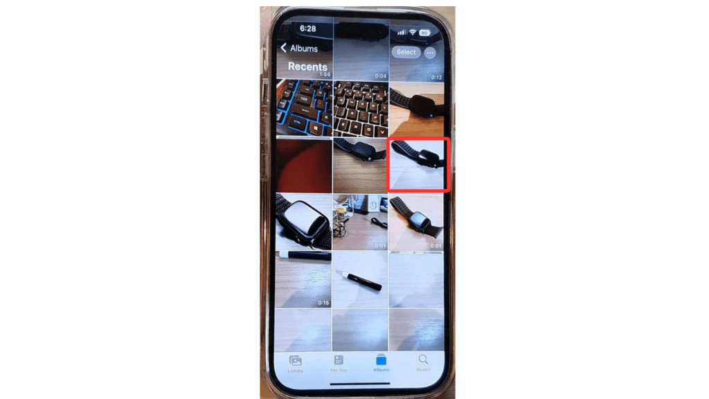 Selecting a photo from the iPhone's media library to edit