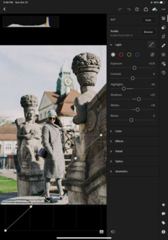 Photographer using an Apple Pencil on an iPad to edit a photo