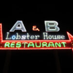 A&B Lobster House neon sign as seen from the Front Street approach, showcasing the iconic branding and inviting atmosphere